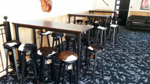 Cowhide bar stools and wooden top leaners